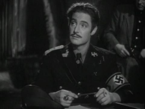 Robert Donat in The Adventures of Tartu (1943)